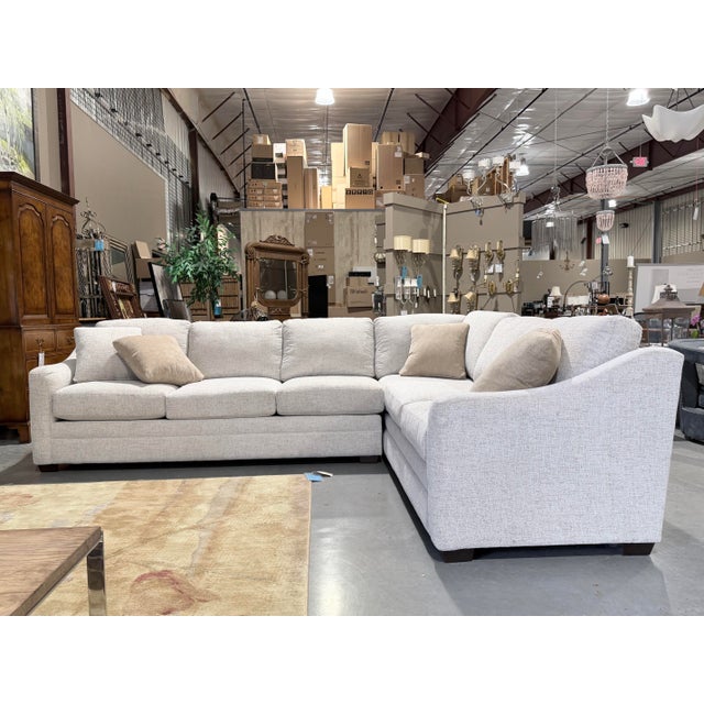 This is a beautifully tailored Craftmaster sectional sofa featuring a clean contemporary silhouette upholstered in a soft...