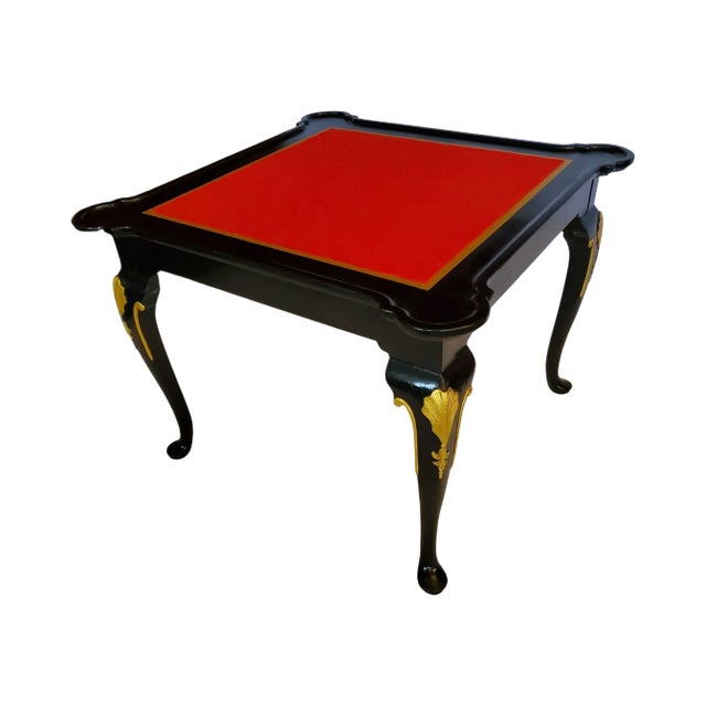 English burled mahogany carved game table with ornate foliate reliefs in the Queen Anne style - circa 1940. Black with...