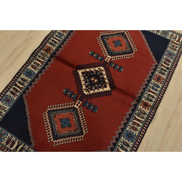 An authentic vintage tribal Yalameh rug hand-knotted with fine wool and natural dyes. This intricately woven rug features...