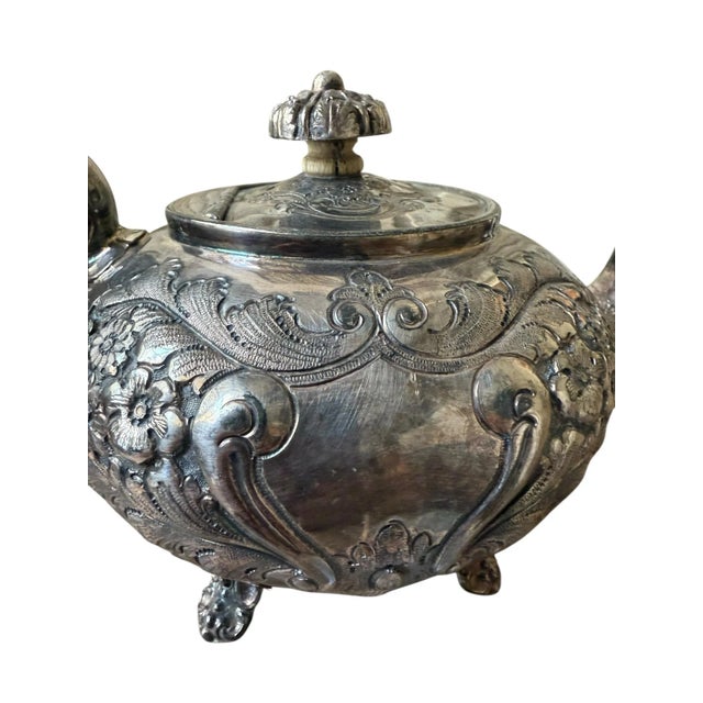 **Product Description:** Experience the elegance of British craftsmanship with this exquisite silver-plated teapot from...
