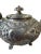 **Product Description:** Experience the elegance of British craftsmanship with this exquisite silver-plated teapot from...