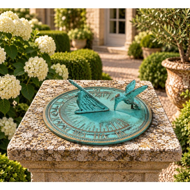 A classic vintage iron verdigris garden sundial inspired by traditional English estate landscapes, featuring a charming...