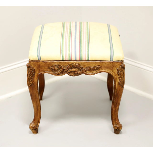 A French Country style bench footstool, unbranded, similar quality to Henredon. Walnut with a distressed finish, yellow,...
