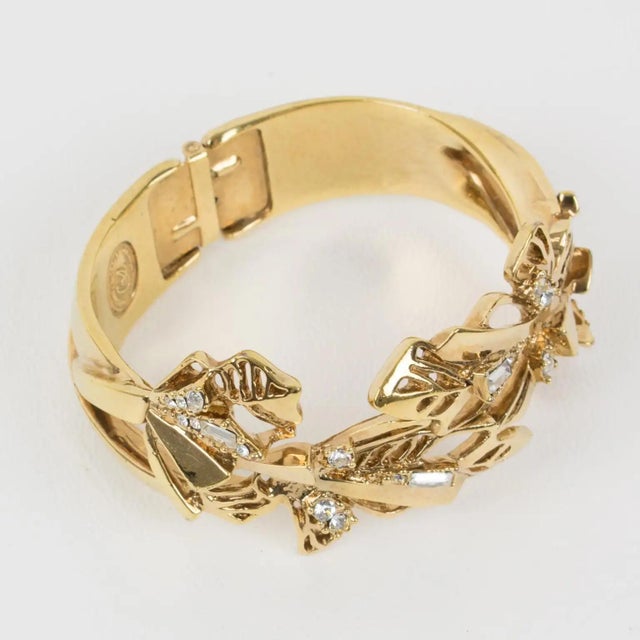 This lovely Christian Lacroix Paris clamper bracelet boasts rich baroque ornamental detailing featuring a stylized floral...
