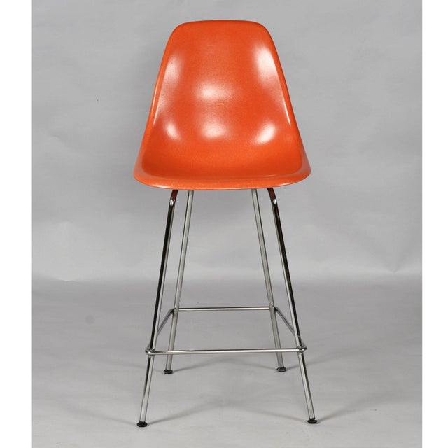 Rare set of three Charles Eames for Herman Miller counter height bar stools. The orange fiberglass counter height stools...