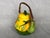 This charming decorative ceramic teapot made in the Majorlica style has a bamboo handle attached to branches on the pot's...
