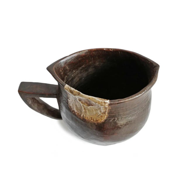 Vintage handmade village pitcher from North Africa. Rich dark wood with original aluminum repairs and traditional...