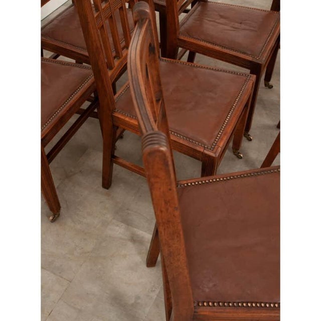 Dimensions: 39”H x 18-⅞”W x 19-¼”D English set of eight Arts and Crafts style dining chairs of impressive quality and...