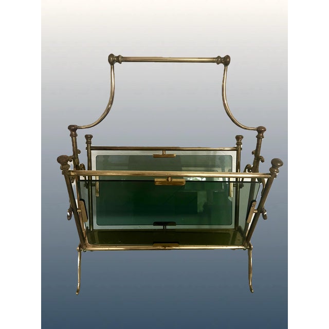 An elegant magazine & newspaper rack, made in France circa the 1950-60's from brass and smokey gray glass. Brass...