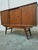 Elegant wooden sideboard with a classic and functional design. – Sliding doors with round handles. – Tapered legs provide...