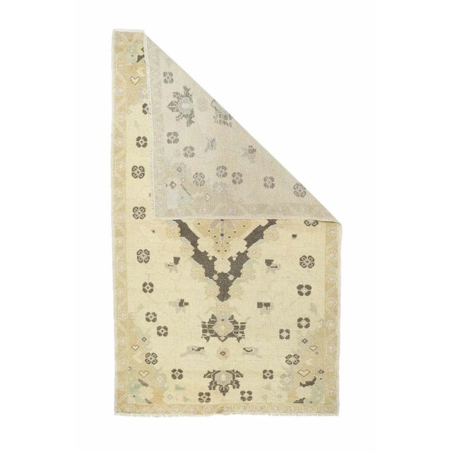 A predominantly light colored scatter with a sand vertical lozenge medallion set on a close, open red field. Doubled...