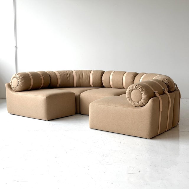 c 1970s. France. Modular 6 piece sectional sofa, reupholstered in brown wool. New veg tanned leather straps. Tagged 6...