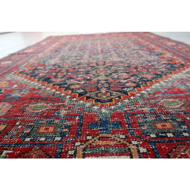 A striking handmade antique Persian Hamadan rug, dating from the 1920s, featuring a richly patterned geometric design...
