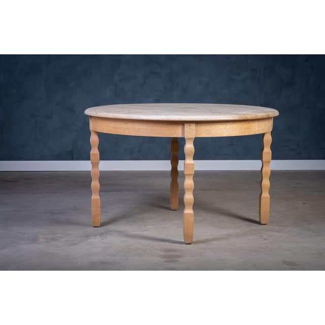 Dining table in solid, lye-treated oak, designed by Henning Kjærnulf in the 1970s. The table features a bold Brutalist...