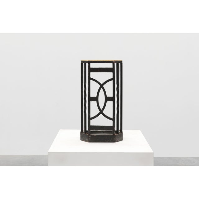 An elegant Belgian Art Deco umbrella stand from the 1920s, featuring a geometric openwork design in black‑painted metal...