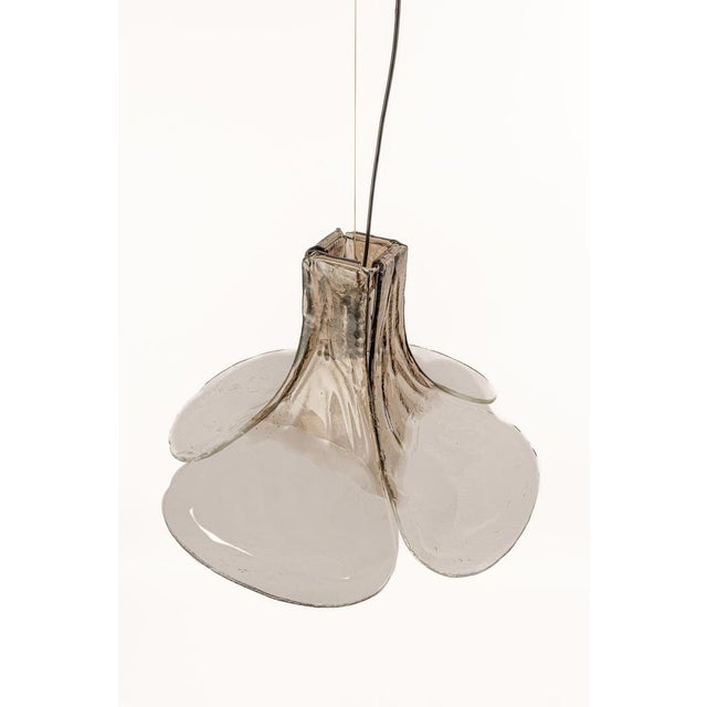 Wonderful floral pendant light with four hand-made clear and smoked murano glass petals which are supported by a metal...