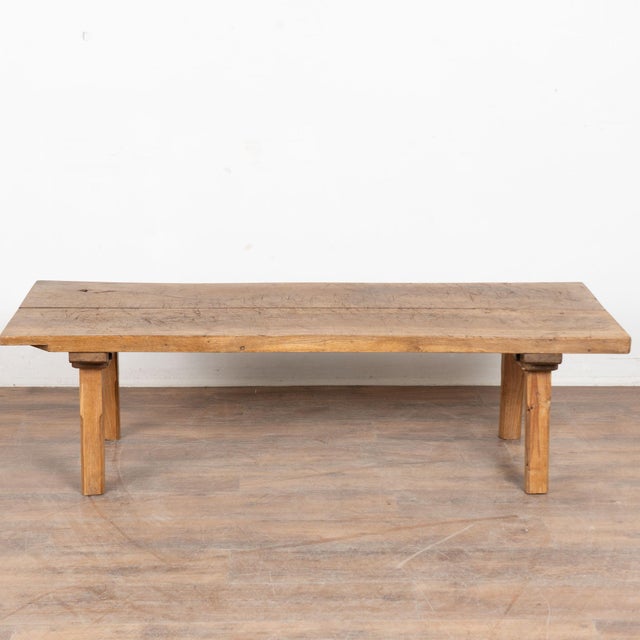 The appeal of this rustic coffee table comes from the thick hard wood top that originally served as a work table, resting...