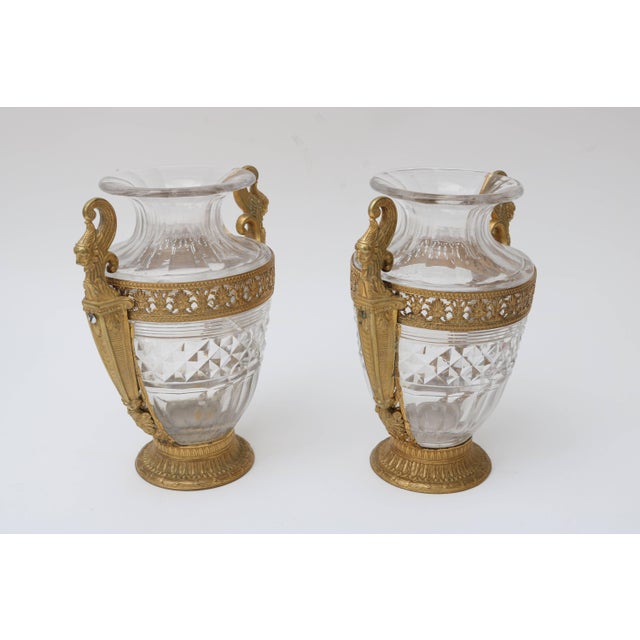 This pair of French 2nd Empire vases date from the late 19th century and are fabricated in hand-cut crystal and cast...