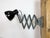 This vintage Industrial adjustable scissor wall lamp was produced in former Czechoslovakia during the 1950s. The lamp has...