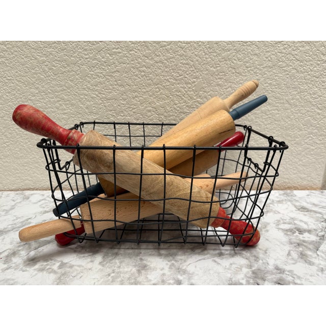 Vintage rustic wood assortment of aged and naturally distressed rolling pins in a black metal farmhouse basket. Fun rustic...