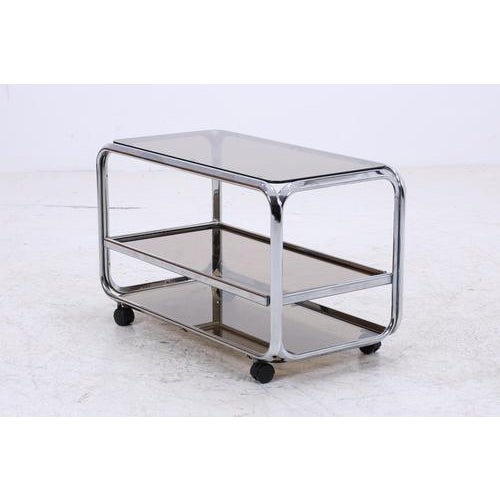 Beautiful vintage bar table made of chrome and glass with a clean, light shape and typical 70s lines. Two levels on...