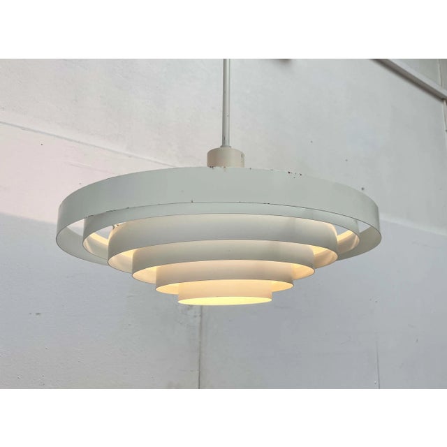 Minimalist rod pendant from the traditional finnish company idman. The design is attributed to paavo tynell. a functional...