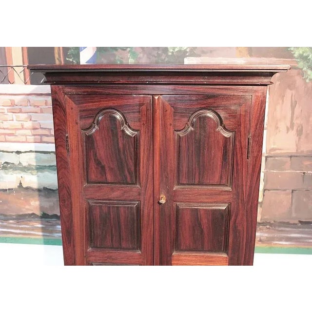 Small rosewood cabinet in the style Louis XIV from Pondicherry. It opens with two doors 3 panel and 2 drawers at the...