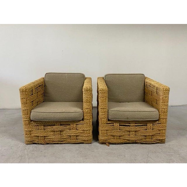 Authentic Adrien Audoux and Frida Minnet french armchairs with plaque, circa 1950. They're made of raffia, oak, and...