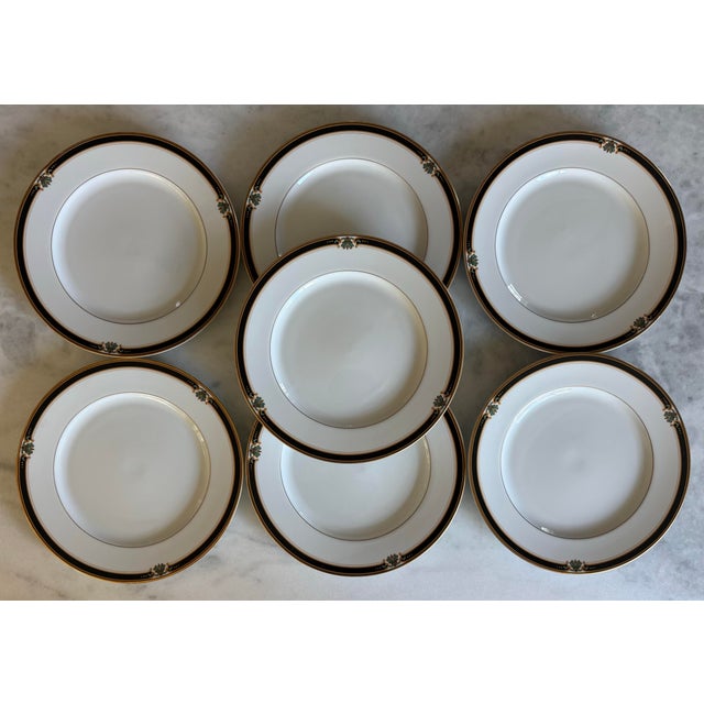 Set of 7 vintage dinner plates in the Strasbourg pattern featuring a black band with green and red floral accents and gold...