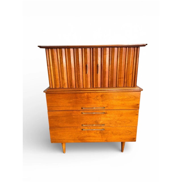 Beautiful mid century highboy dresser by Young Manufacturing, crafted in walnut with sculpted cabinet doors and a gently...