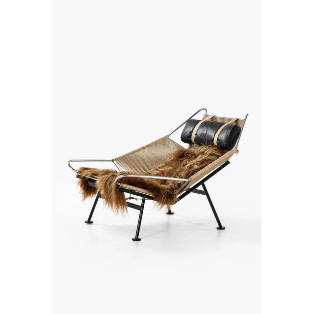 Rare lounge chair / flag halyard chair designed by hans wegner produced by getama in denmark metal, flagline, sheepskin,...