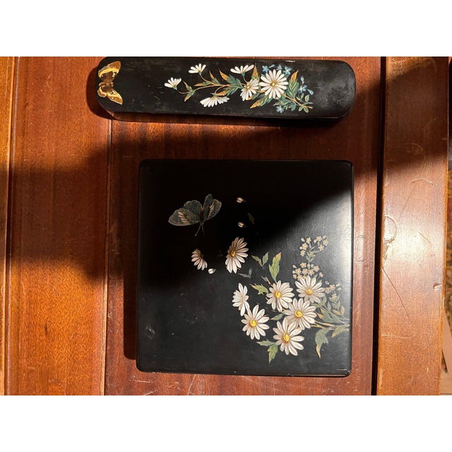 An exquisite antique 2-piece Japanese black lacquer (urushi) desk set featuring delicate hand-painted white...