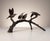 Charming bronze sculpture depicting four hummingbirds arranged upon a naturalistic tree branch Two birds are shown perched...