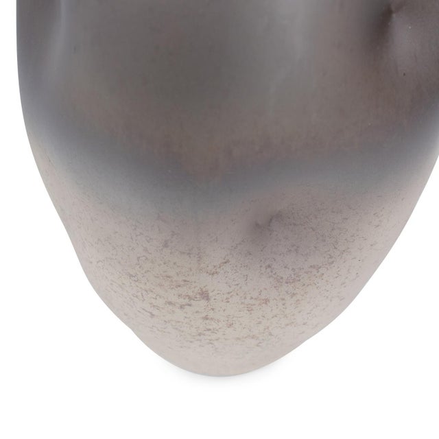 This hand-blown vase features a captivating ombre effect, blending cool gray and aubergine with warm beige and gold. With...