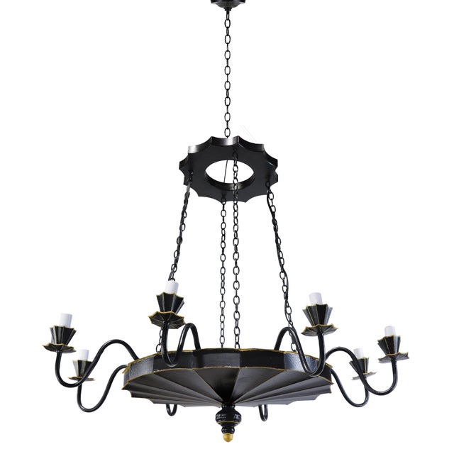 A stunning handcrafted 8-light chandelier in wrought iron, finished in classic black with subtle gold accents. This unique...