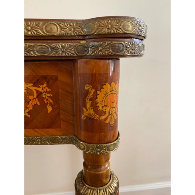 A 20th century Louis XVI revival game and card table with a green leather game top with gold and silver tooled trim. The...