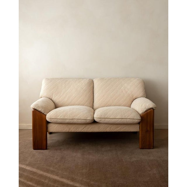 A vintage italian sapporo two-seater sofa in walnut and original cream-beige upholstery, designed by mario marenco for...