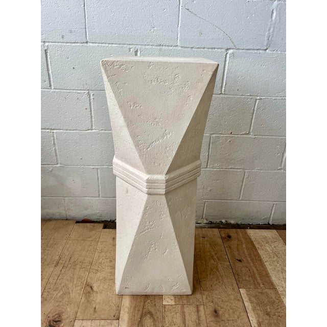 A striking Postmodern pedestal featuring an architectural faceted silhouette and textured plaster-like finish. The...