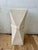 A striking Postmodern pedestal featuring an architectural faceted silhouette and textured plaster-like finish. The...