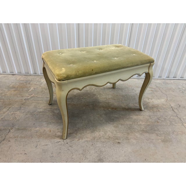 Classic 1960’s-1970’s French provincial boudoir bench from Hibriten Furniture Co. Simple creamy off white finish on a...