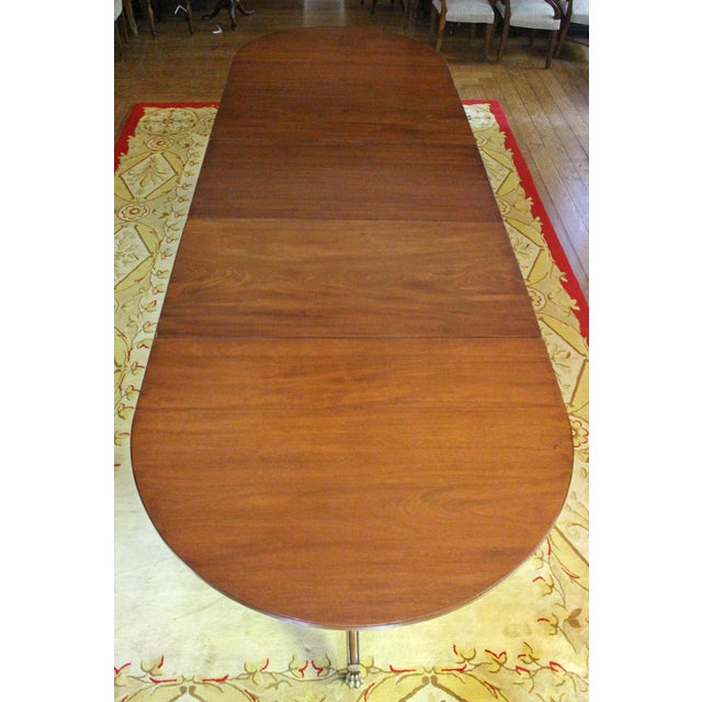 Regency early 19th century & later triple pedestal dining table with 2 leaves, English. Raised on turned pedestals with...