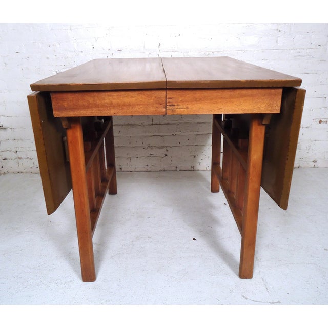 Vintage modern drop leaf dining table extending to 60"W open, 30" closed. One or both leaves can open for multiple seating...