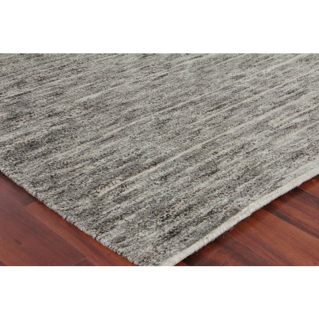 The Eaton rug is hand knotted with a low nubby wool pile with a shimmer of bamboo fiber for highlights. This collection...