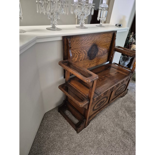 This piece is an antique English Jacobean Revival style monk's bench (also known as a settle bench,) likely crafted in the...