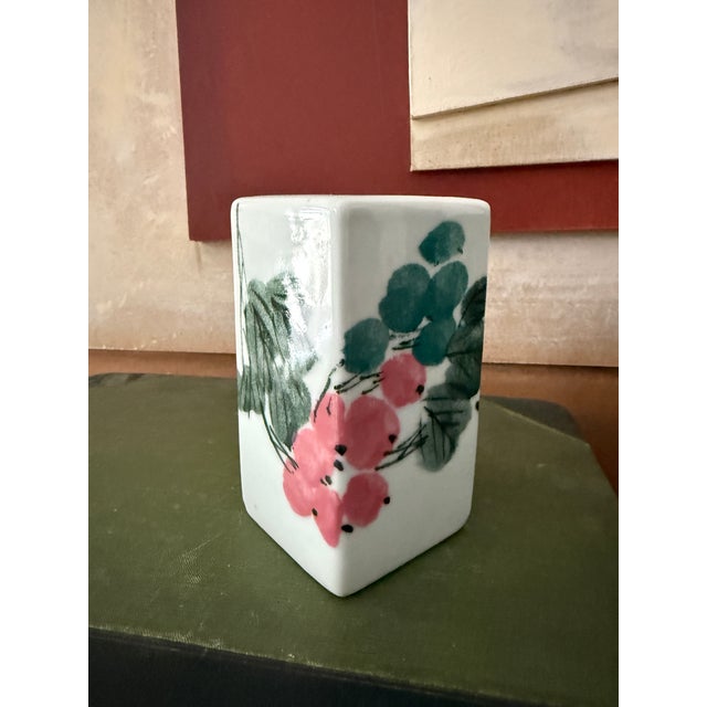 This signed Japanese studio porcelain bud vase features a minimalist rectangular form with hand-painted floral decoration....