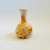 A vintage nemadji pottery vase with a beautiful organic pattern of orange swirls on a light off-white background. Matte...