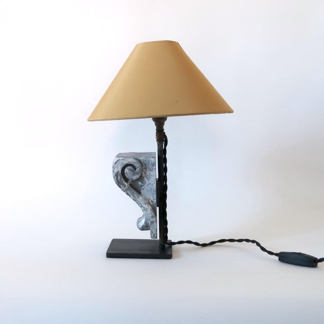 A one-of-a-kind! Our “fragment” lamps are comprised of a carved hardwood corbel mounted on a bespoke black metal stand....