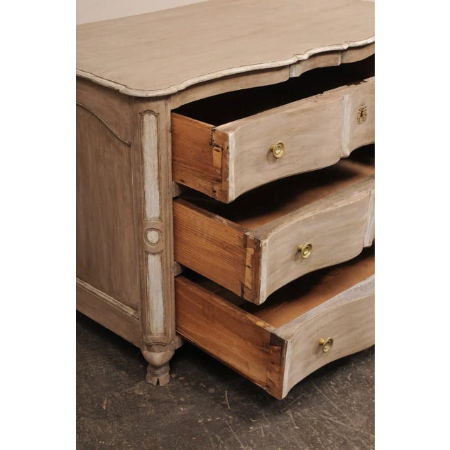 An Italian serpentine chest of three drawers, with front cloven feet, from the turn of the 18th and 19th century. This...