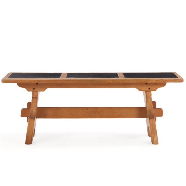 A handsome French dining table crafted in solid oak, featuring a substantial rectangular top inset with three stone panels...