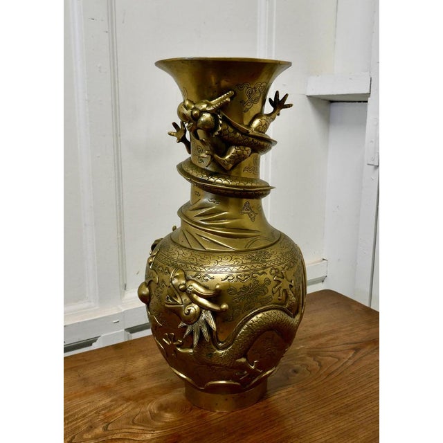 Large Oriental 19th century decorated brass vase This is a large piece decorated in 3D with fierce Dragons and it has a...